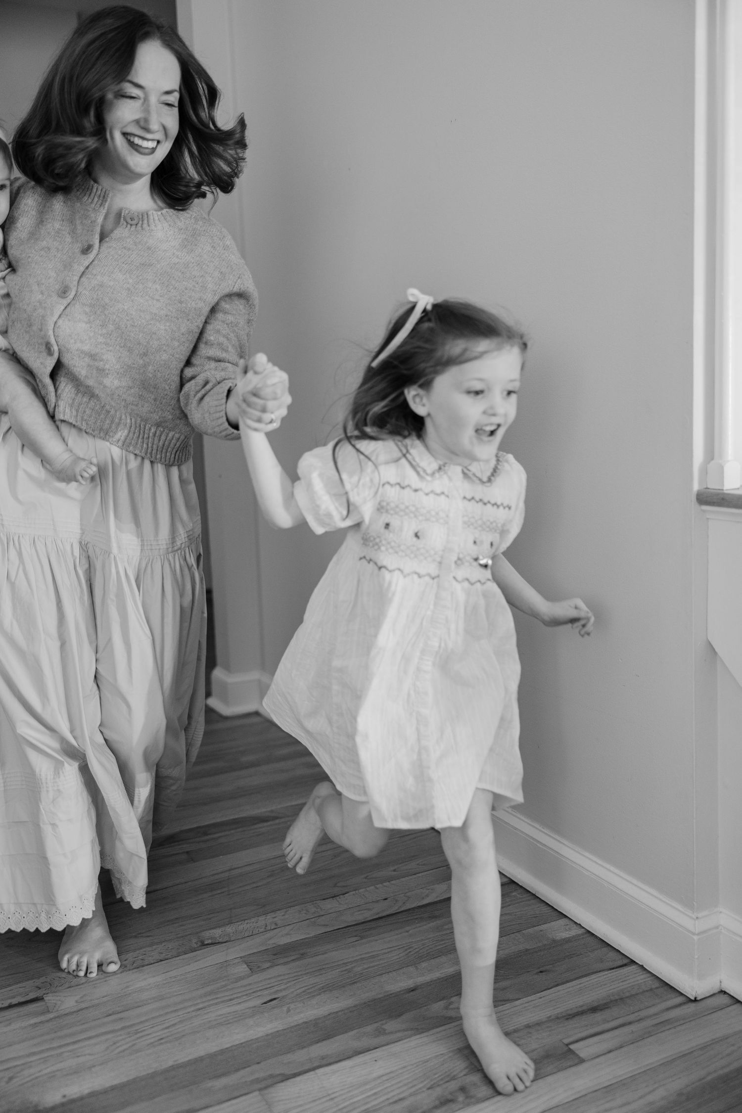 A black and white photo series showing joyful moments of barefoot dancing and movement captured in indoor lighting.