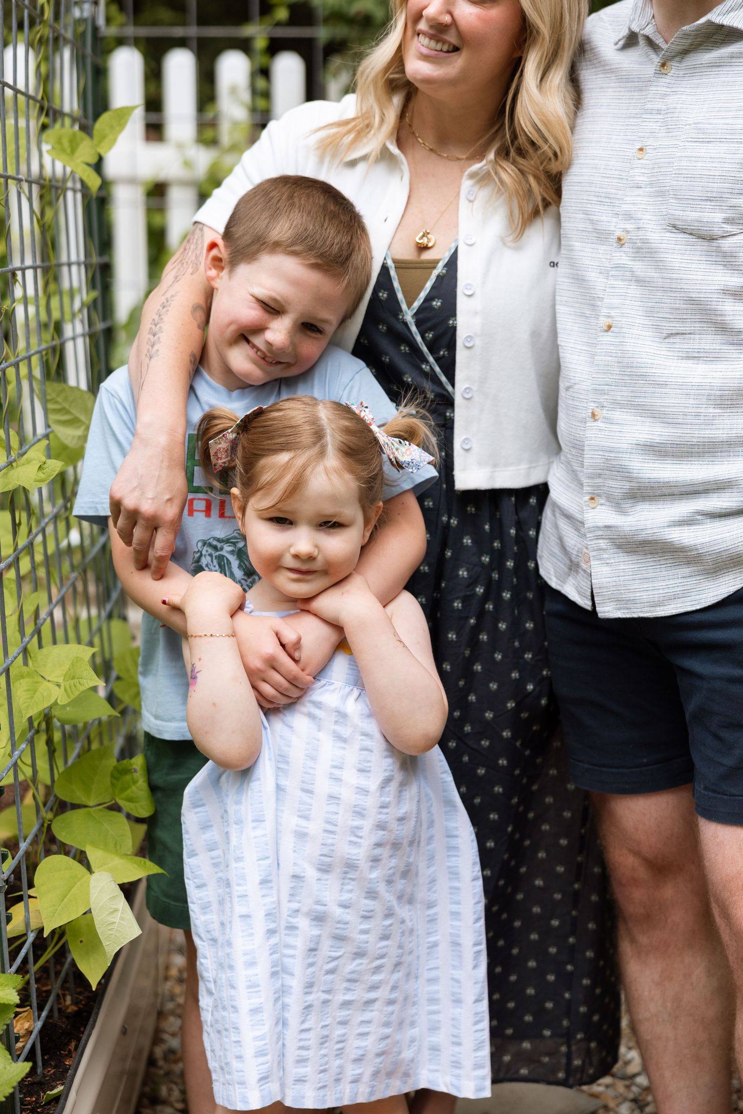 Four candid family photos showing tender moments between loved ones in an outdoor garden setting.