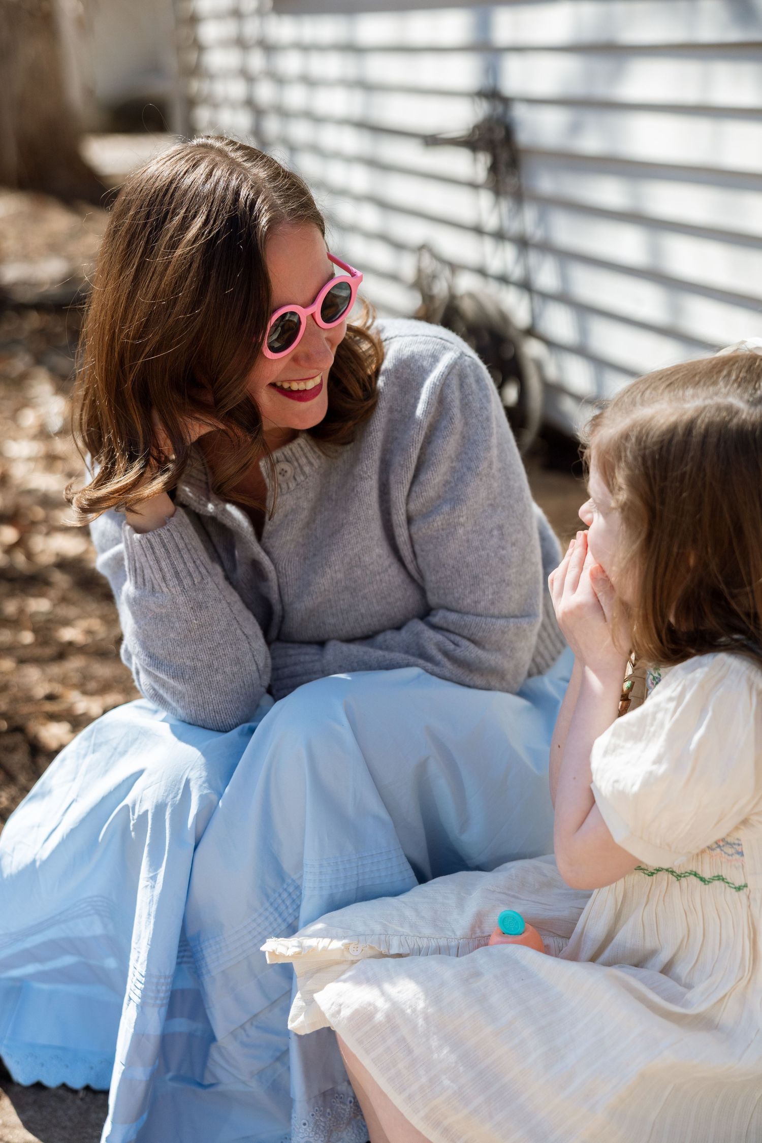 A heartwarming sequence showing affectionate interaction between two people in grey and blue clothing outdoors.