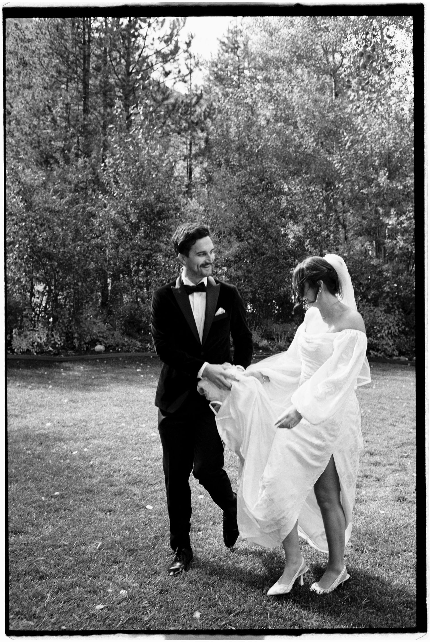 Black and white photo series capturing playful moments in a garden wedding setting.