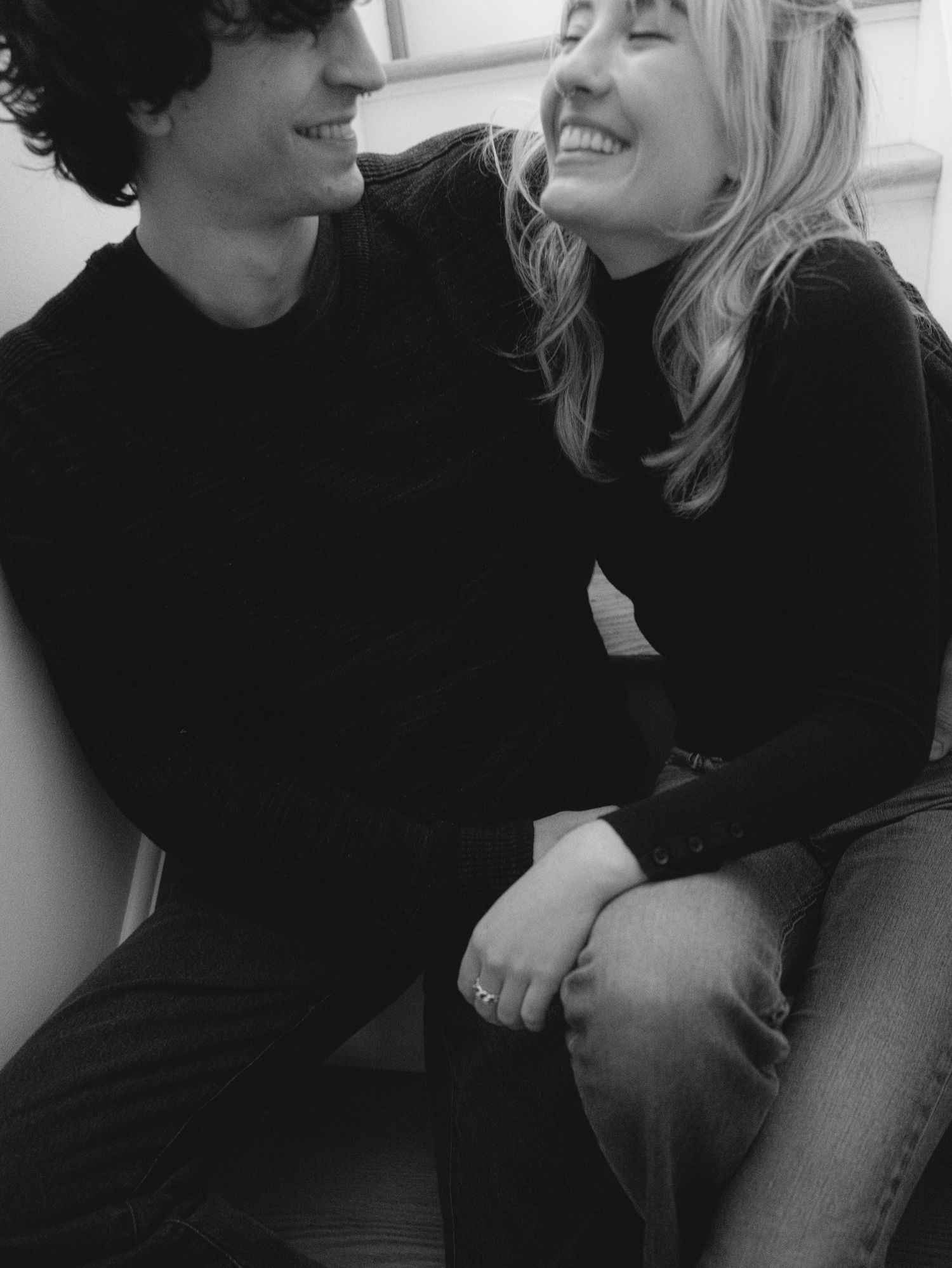 A series of candid black and white photographs showing joyful laughter and intimate moments between two people.