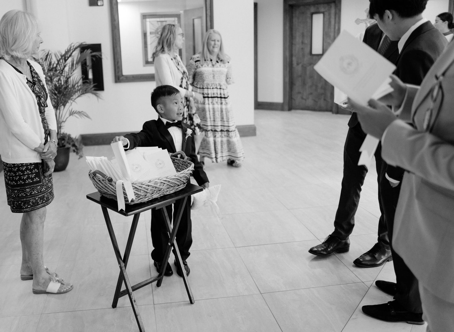 A series of black and white photographs showing legs and feet of people in an art gallery or exhibition space.