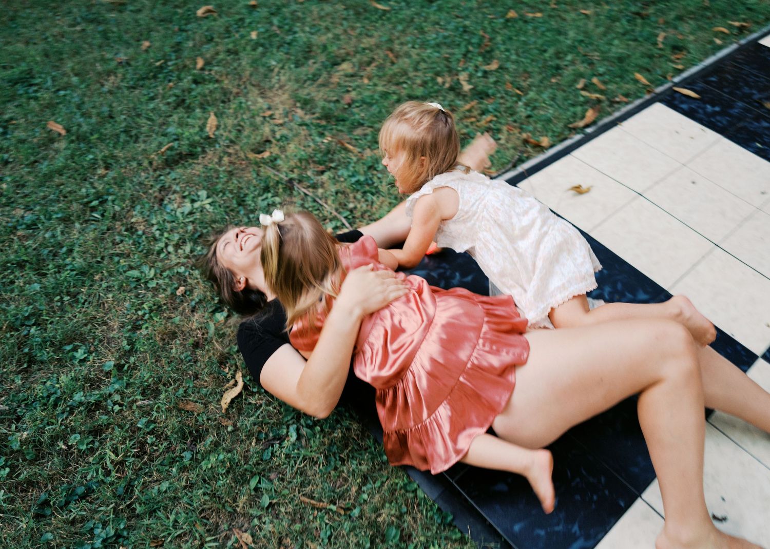 People relaxing on grass during casual outdoor gathering.