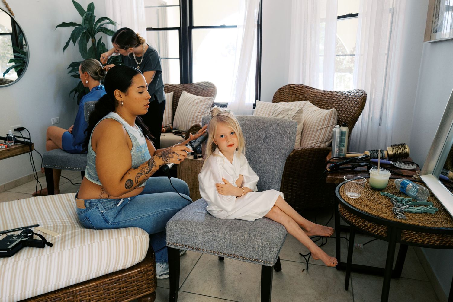 A series of photos showing someone sitting on a couch with a baby in different candid moments at home.