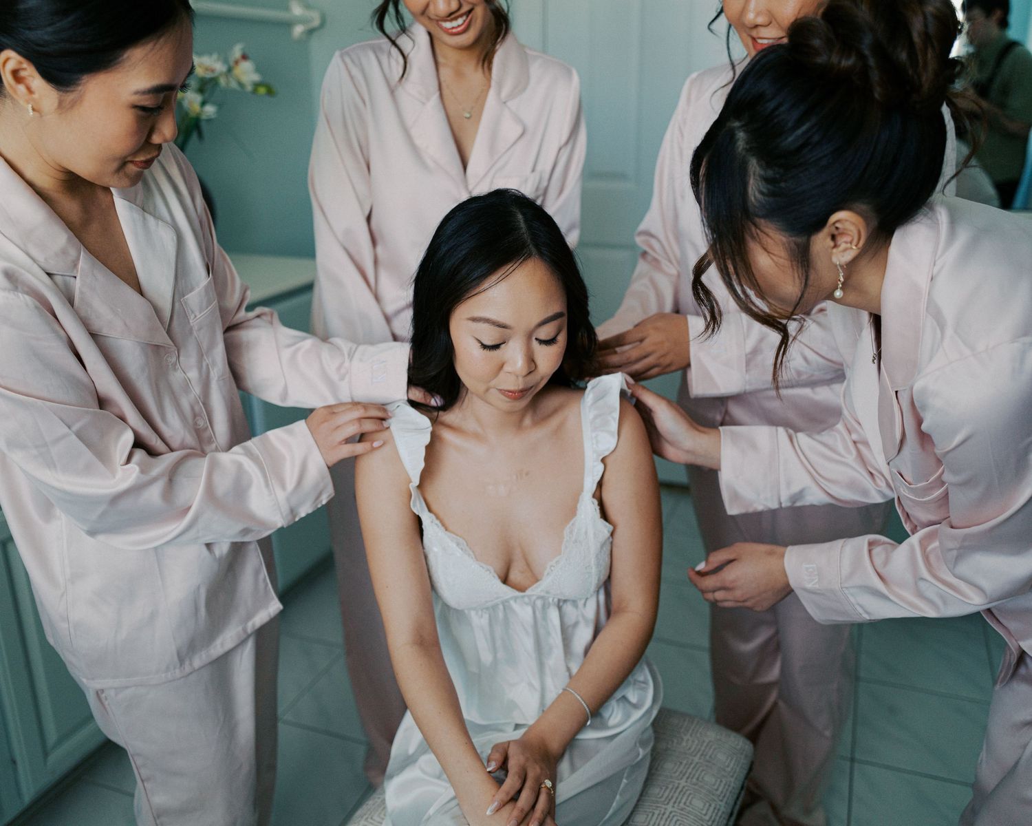A sequence of images showing a makeup artist applying cosmetics during a wedding preparation session.