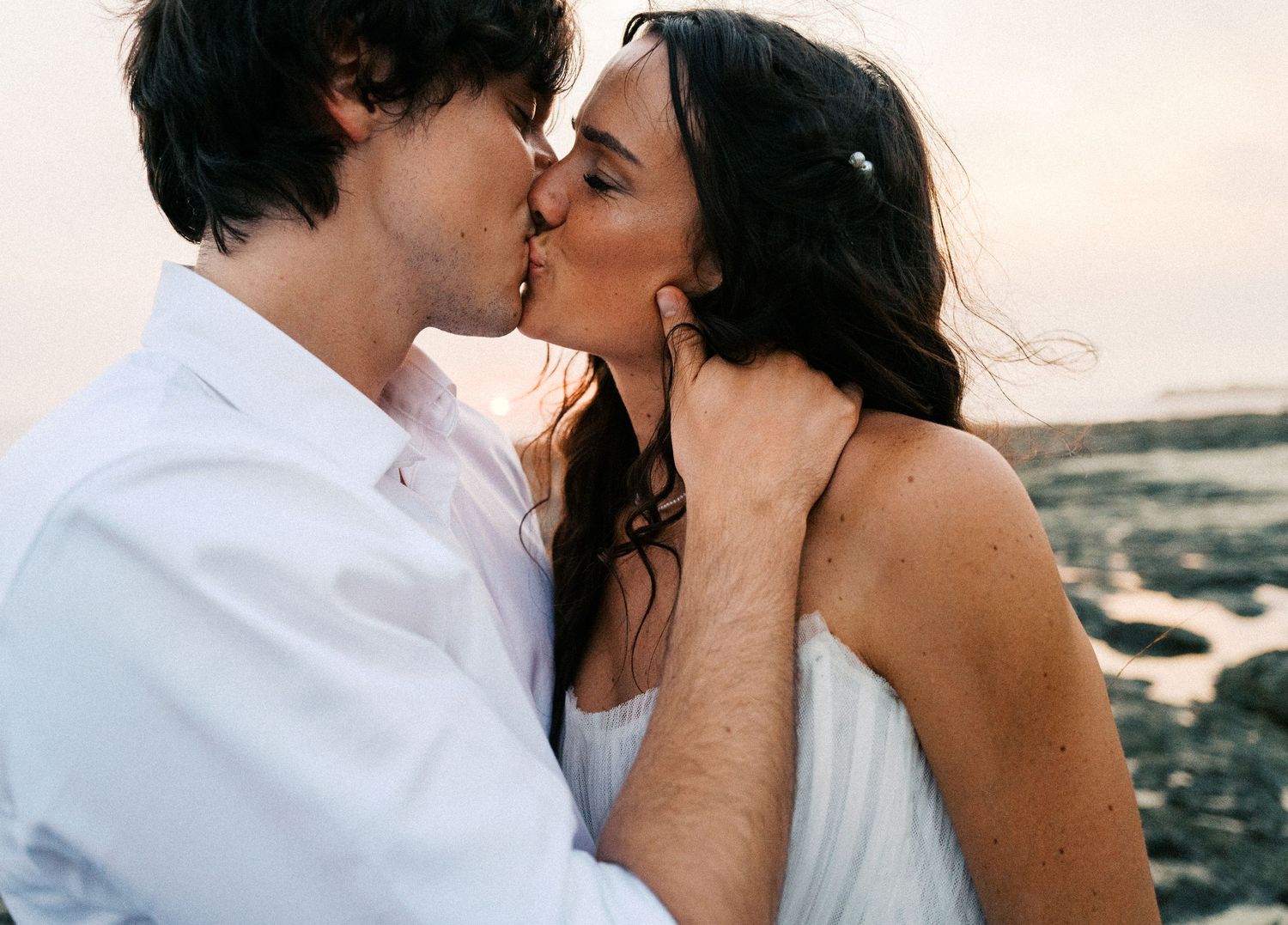 Romantic seaside moment captured in a sequence of intimate photographs.