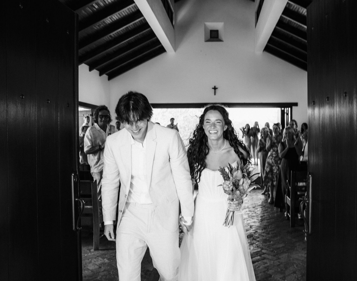 Black and white photo series showing wedding ceremony moments in a church setting with elegant decor and lighting.