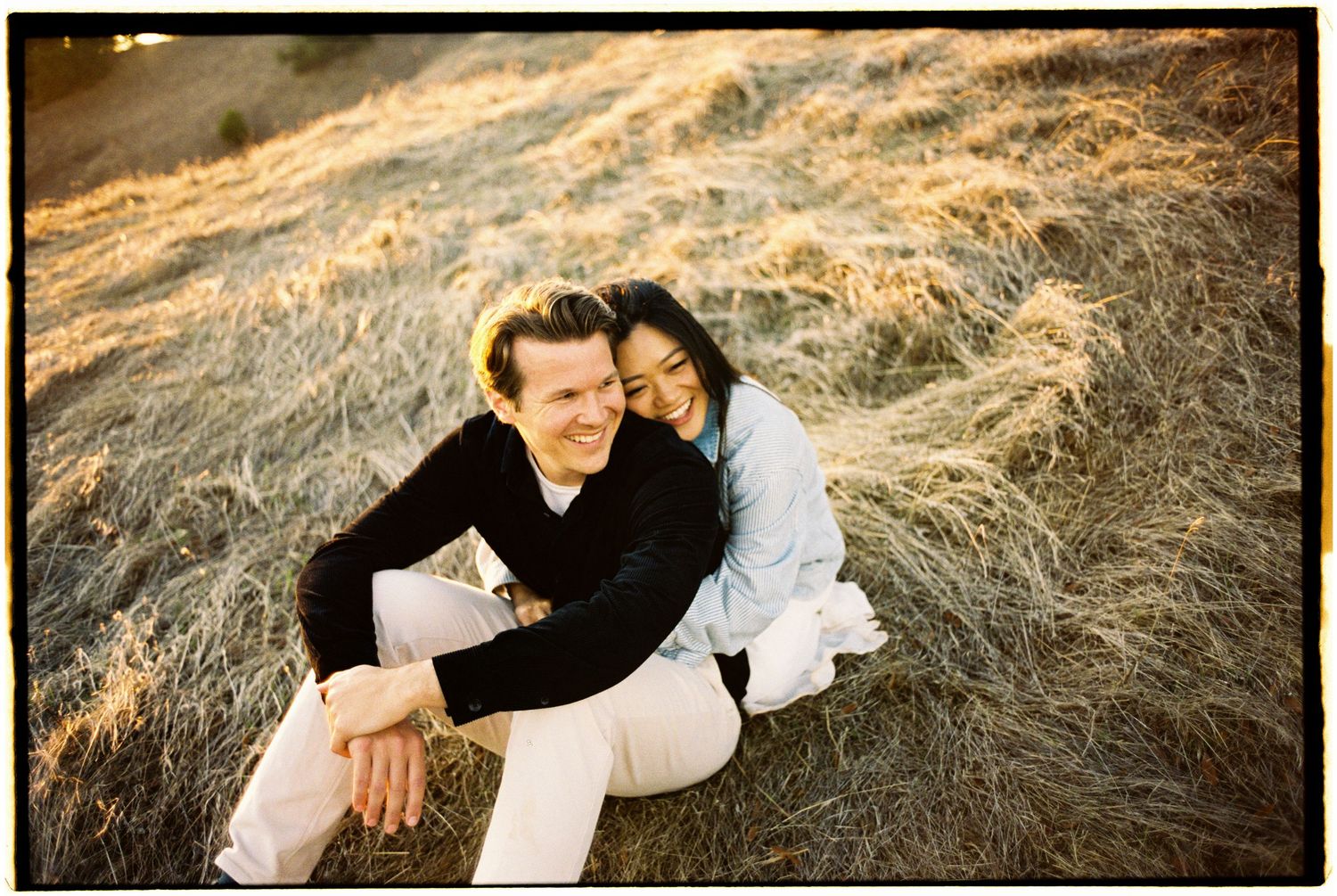A series of six warm-toned artistic portraits showing a person reclining in tall golden grass at sunset.