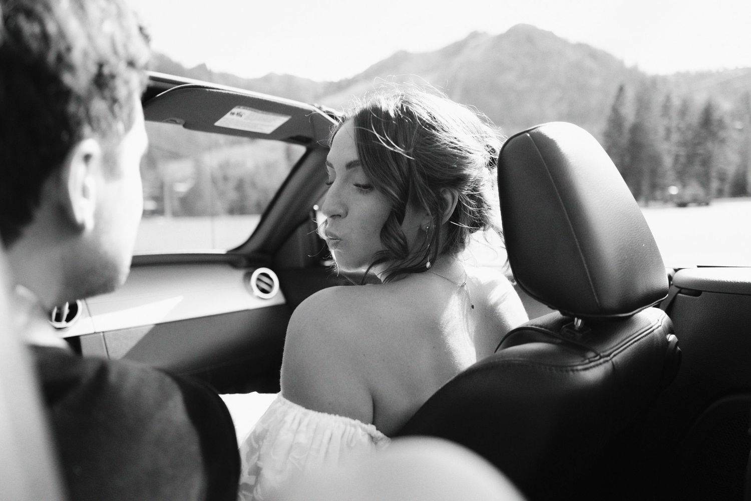 A black and white photo sequence showing intimate moments between a couple in a car on their wedding day.