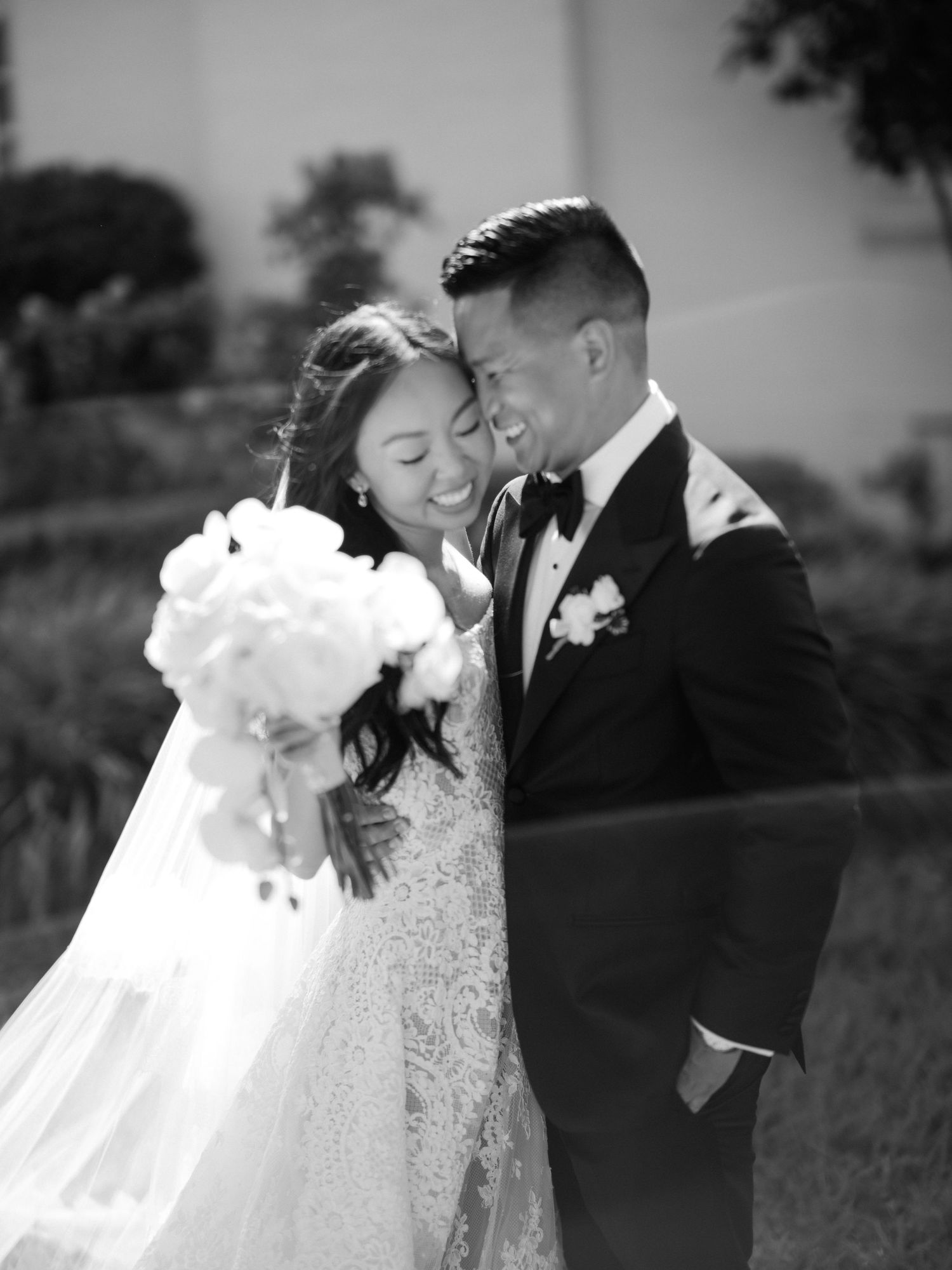 Intimate black and white wedding portraits showing tender moments between newlyweds outdoors.