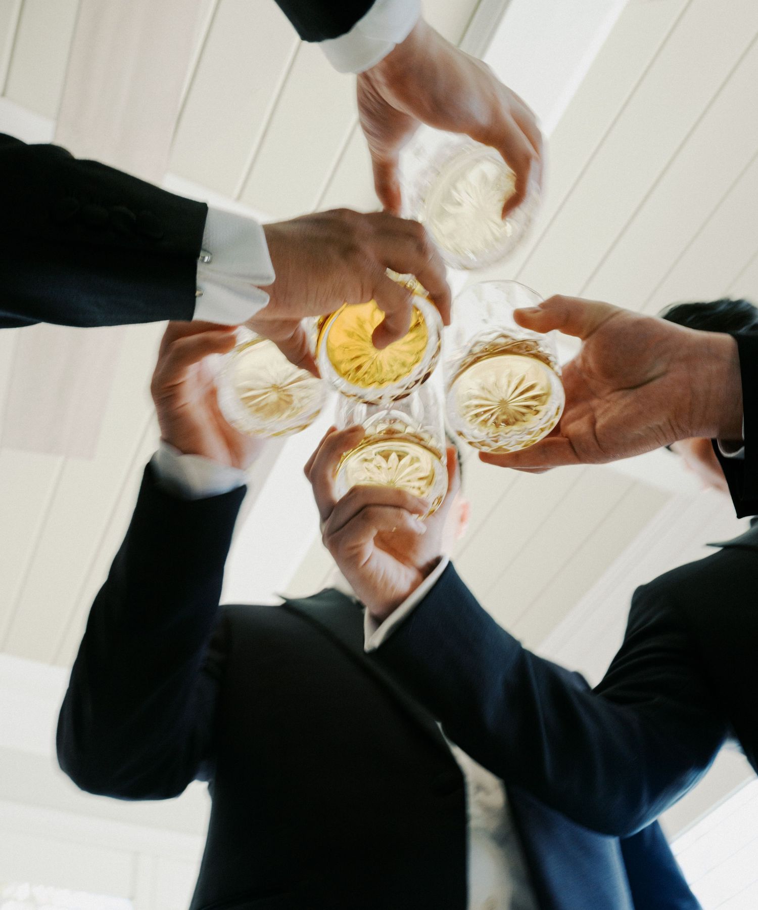 Hands passing and sharing champagne glasses in a celebratory toast sequence.