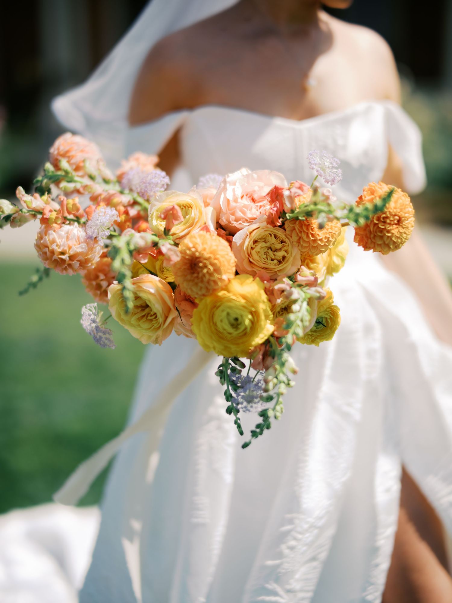 Elegant floral garland featuring peach and coral roses with yellow accents creates a romantic wedding decoration.