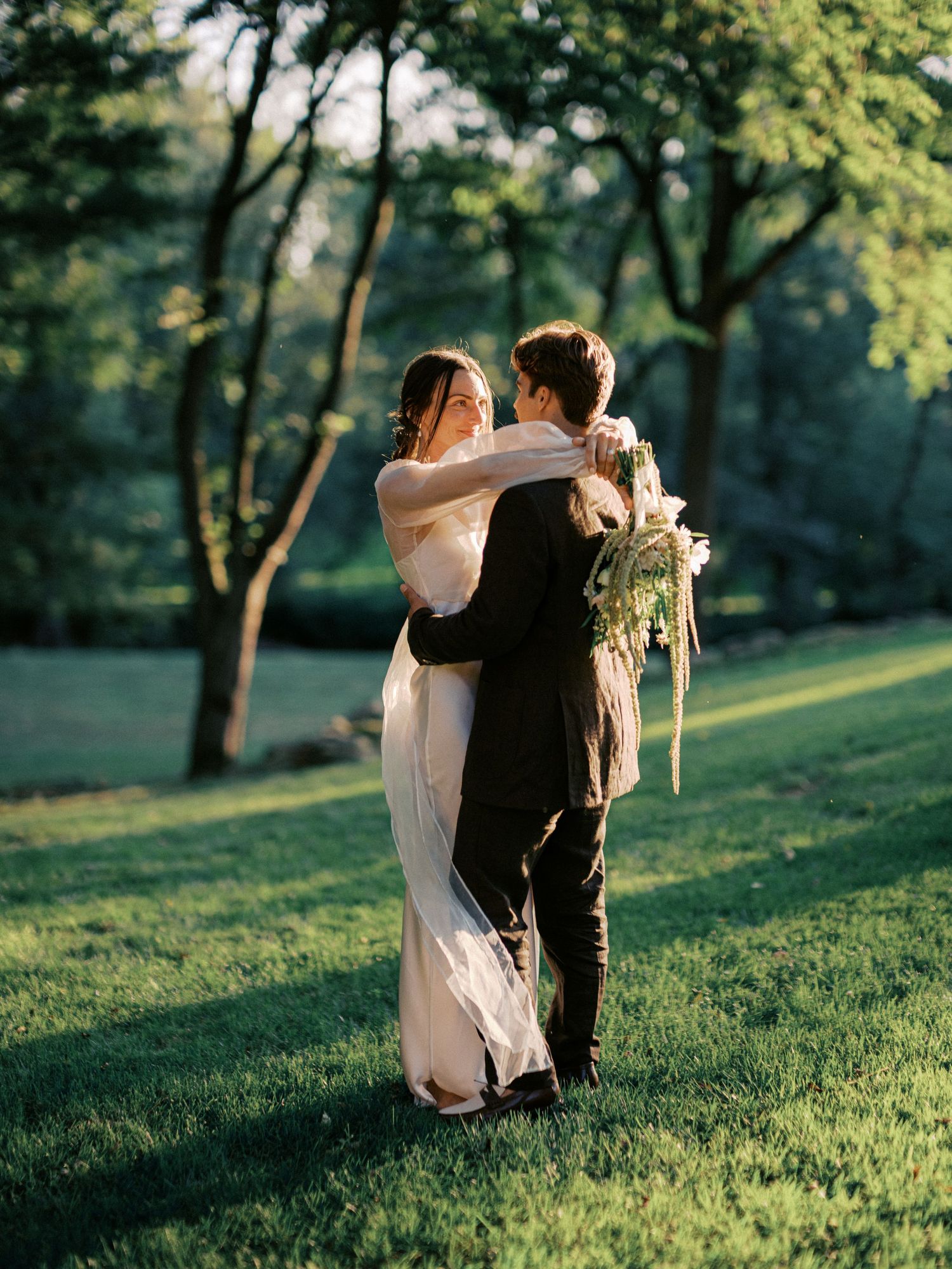 A romantic outdoor dance sequence captured in multiple frames on a grassy hillside.