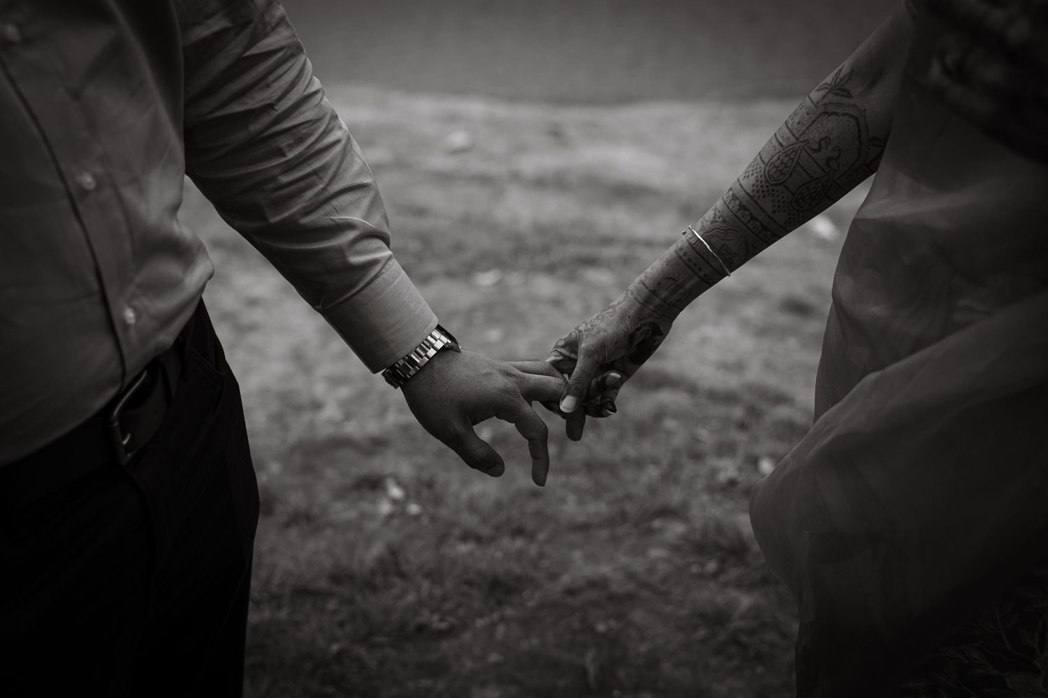 Black and white close-up shots of hands with wedding rings in dramatic lighting.