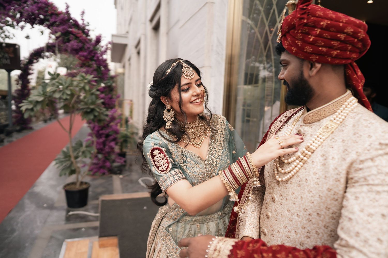 A couple in traditional Indian wedding attire share romantic moments during their wedding celebration.