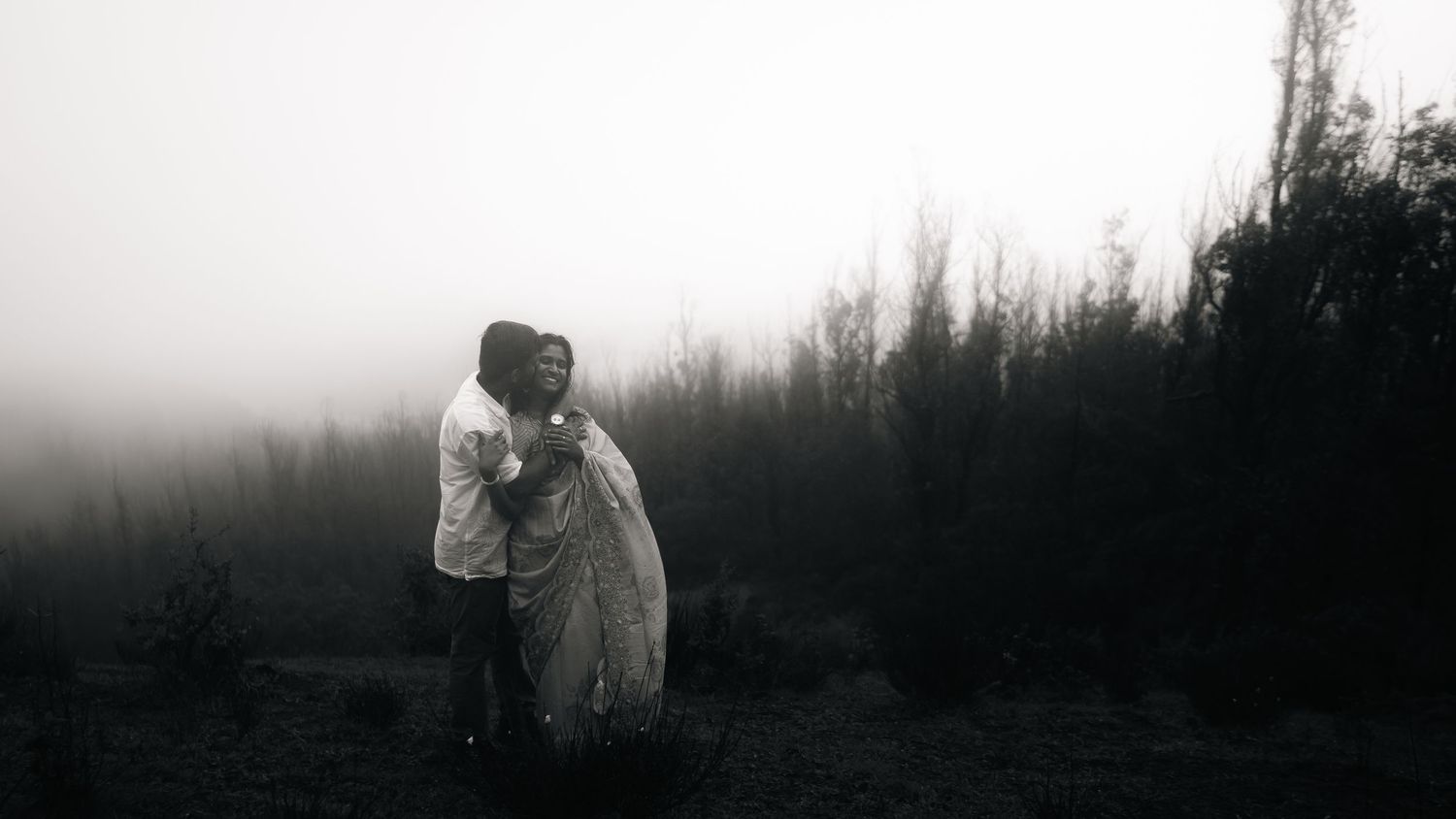 Misty panoramic landscape view with silhouettes creating a moody atmospheric scene.