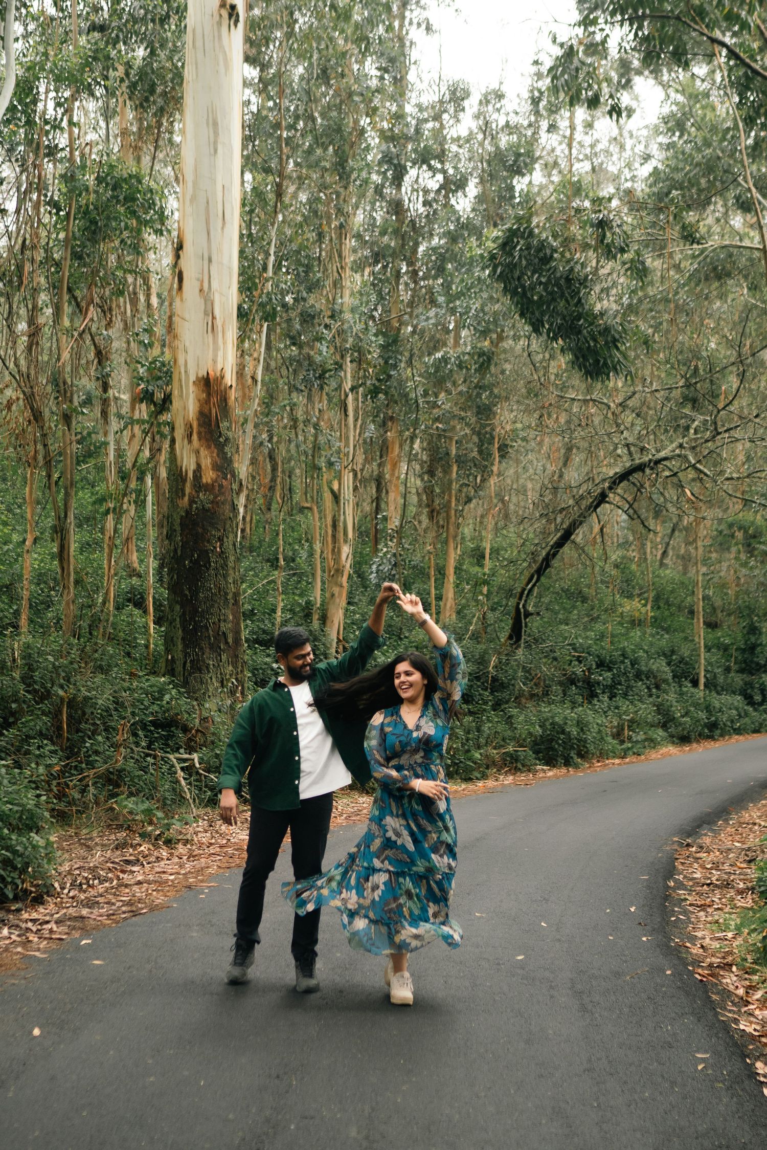 A joyful dance along a winding forest path surrounded by tall eucalyptus trees.