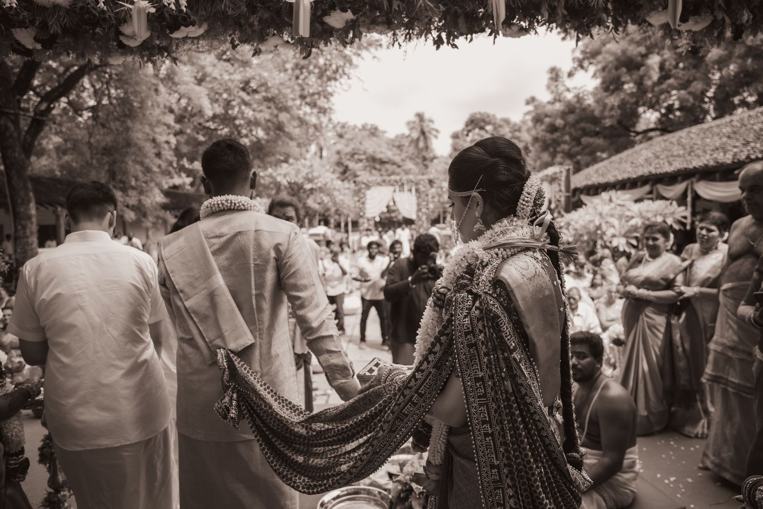 Black and white panoramic shot of people gathered at an outdoor event.