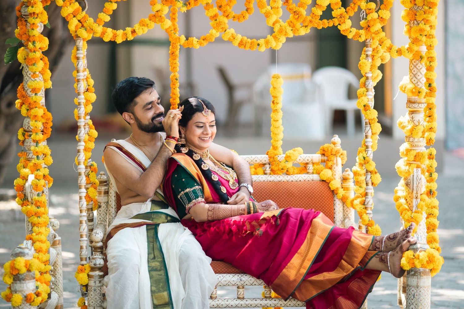 Traditional Indian wedding ceremony adorned with vibrant marigold flower decorations and cultural rituals in progress.