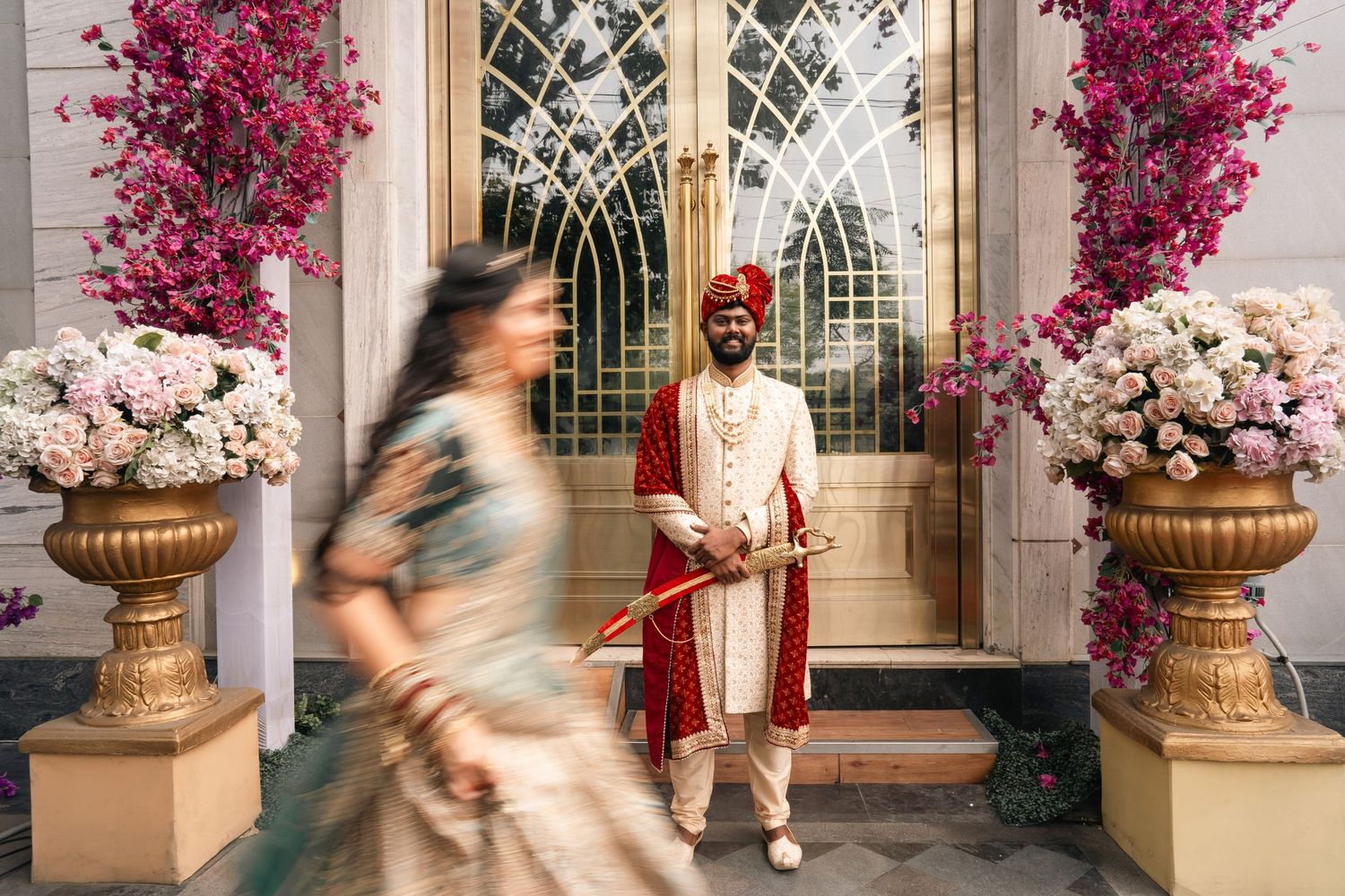 A wedding venue decorated with vibrant pink bougainvillea flowers and elegant architectural details.