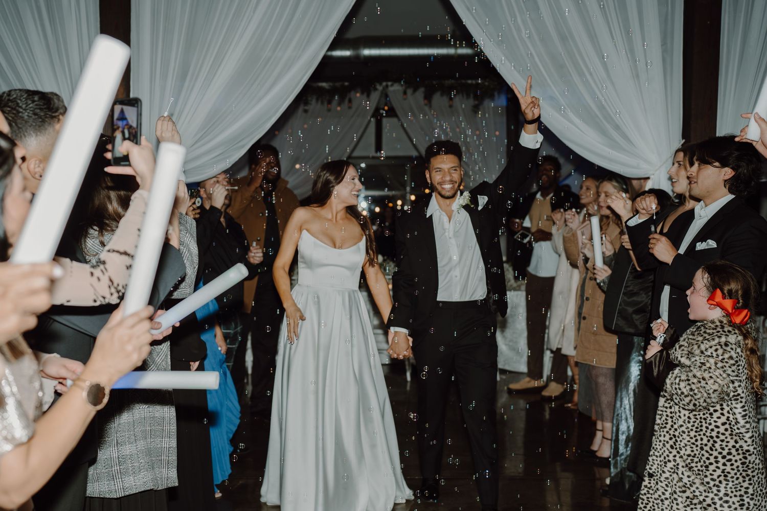 Lively dance floor scene with guests celebrating at an indoor wedding reception.