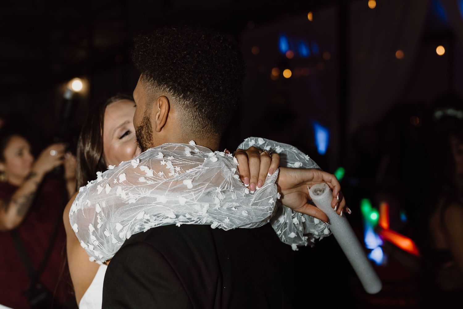 Wedding couple shares an intimate dance moment during their reception celebration.