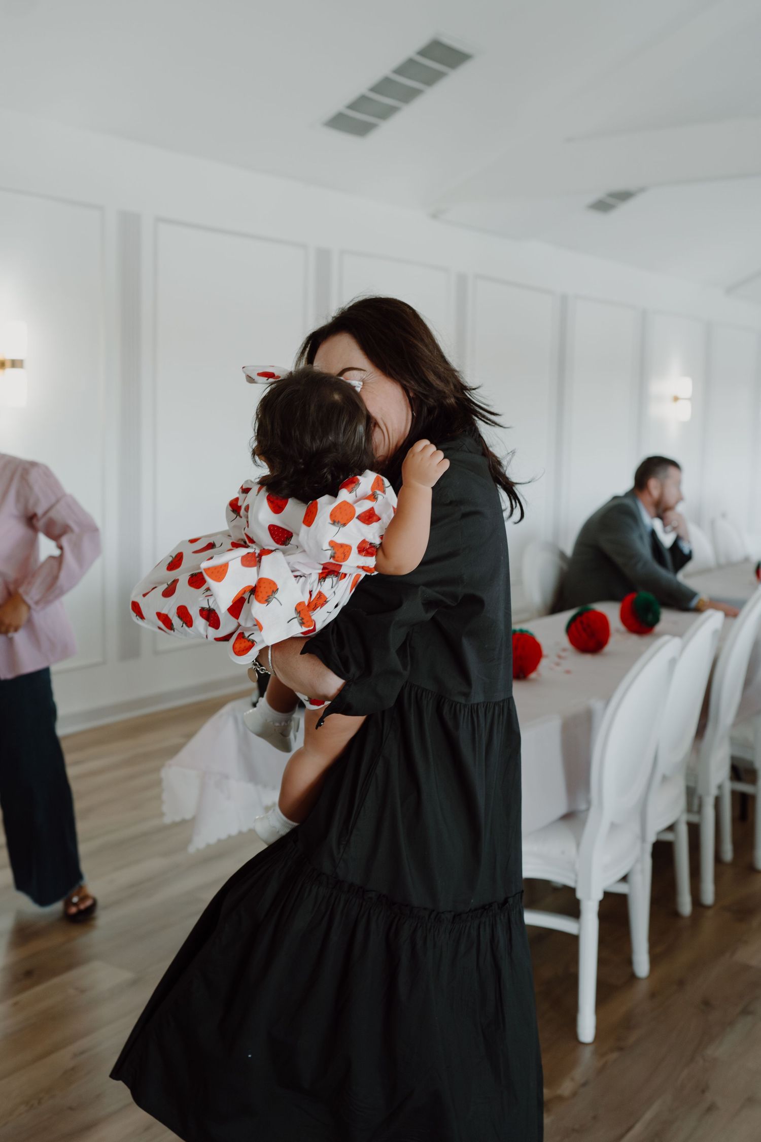 A bright indoor venue with white walls and decorative red heart accents.
