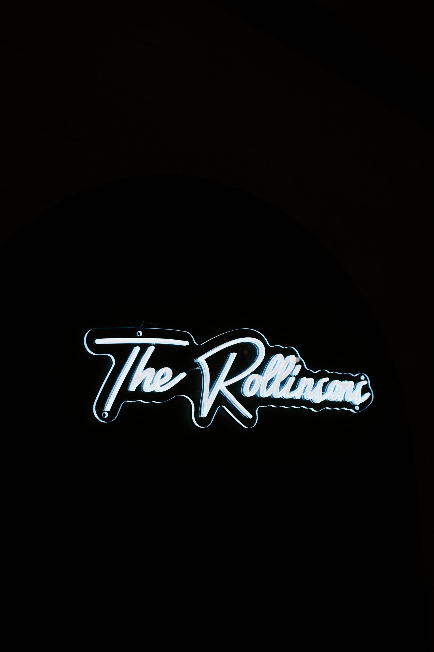 A neon sign reading 'The Robinson' glows against a dark background.