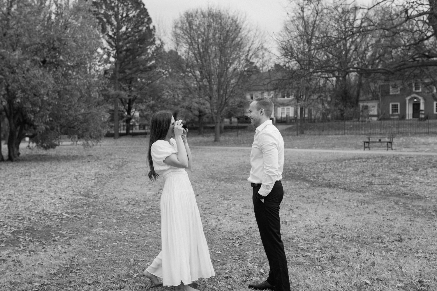 Couple dancing together in an open field during golden hour.