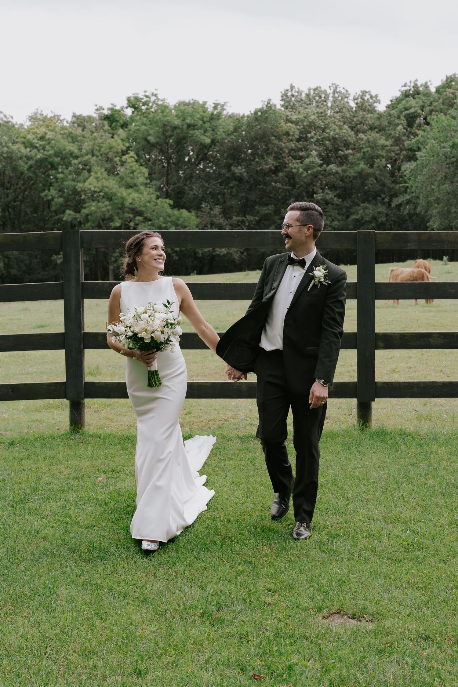 Playful wedding photo sequence showing couple dancing and laughing by farm fence.