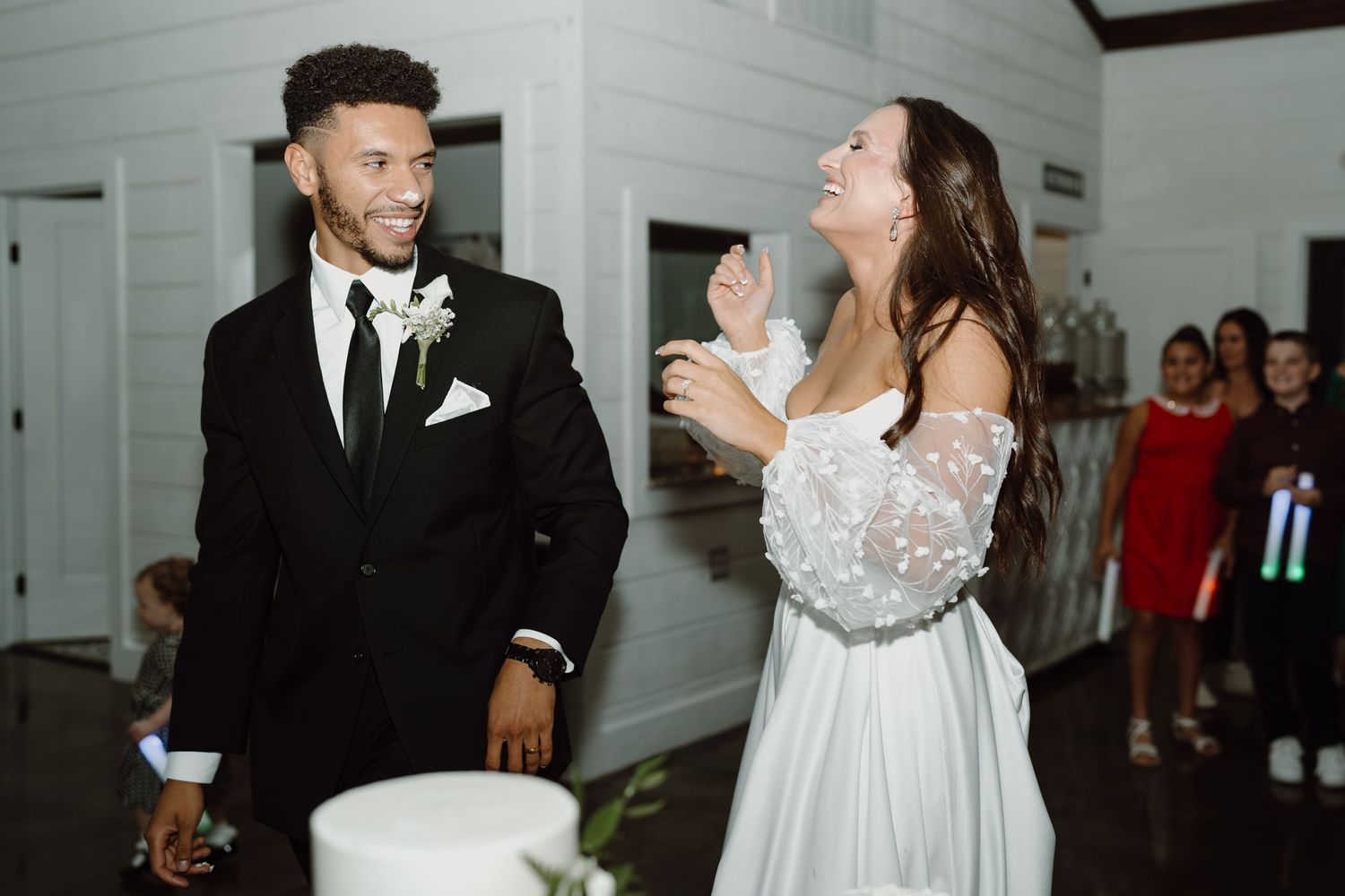 Couples enjoying upbeat dancing at an elegant indoor wedding reception.