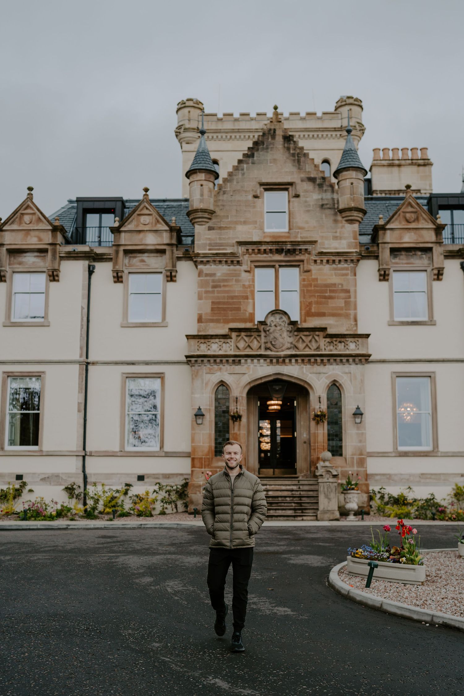 Historic Scottish castle-style building with ornate stone architecture and crenellated towers.