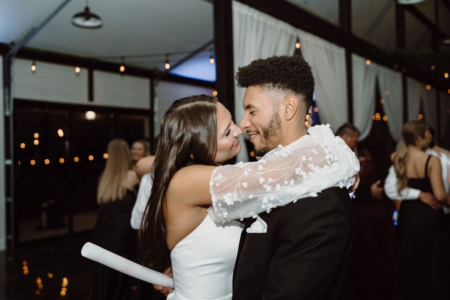 Newlyweds share an intimate dance moment at their wedding reception.