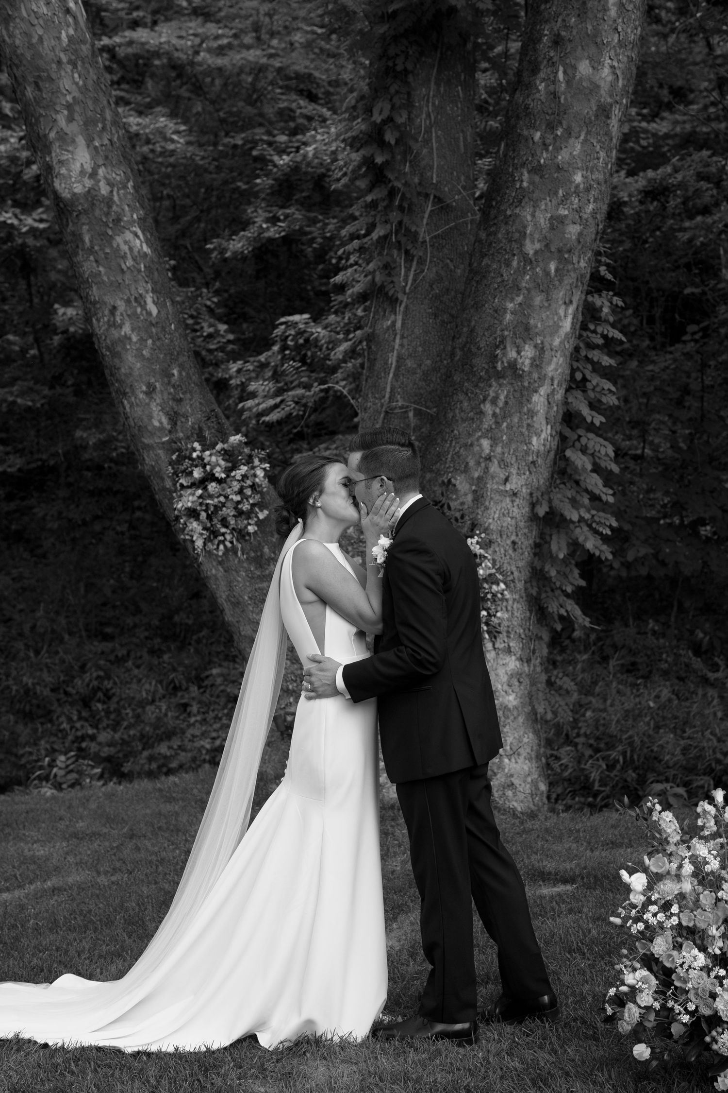 Black and white sequence of newlyweds sharing intimate moments after their forest ceremony.