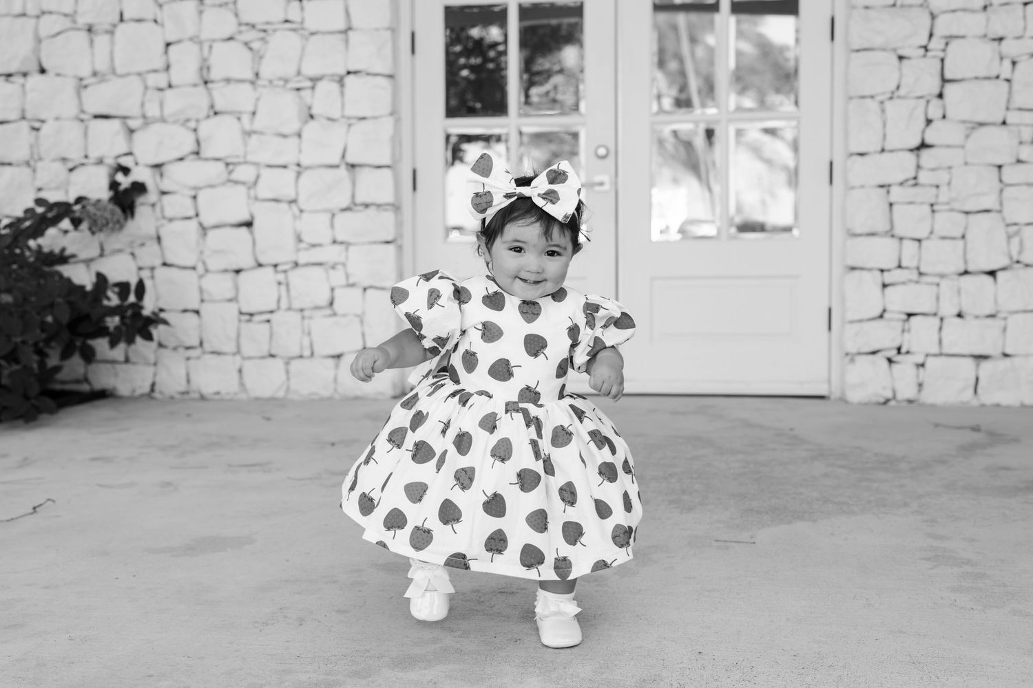 Charming heart-patterned outfit with matching accessories against rustic stone backdrop.