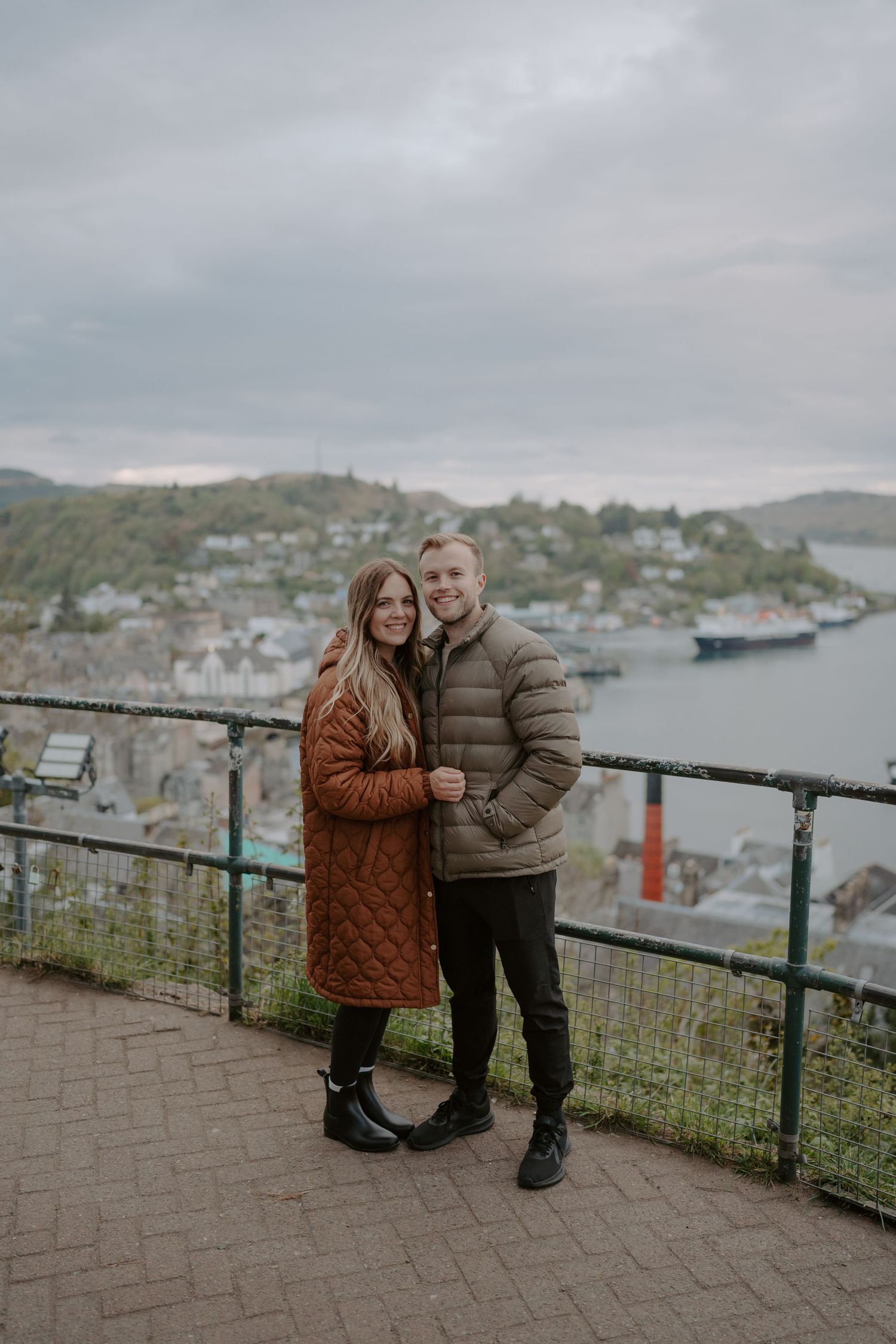 Scenic overlook of a coastal town with harbor views on a cloudy day.