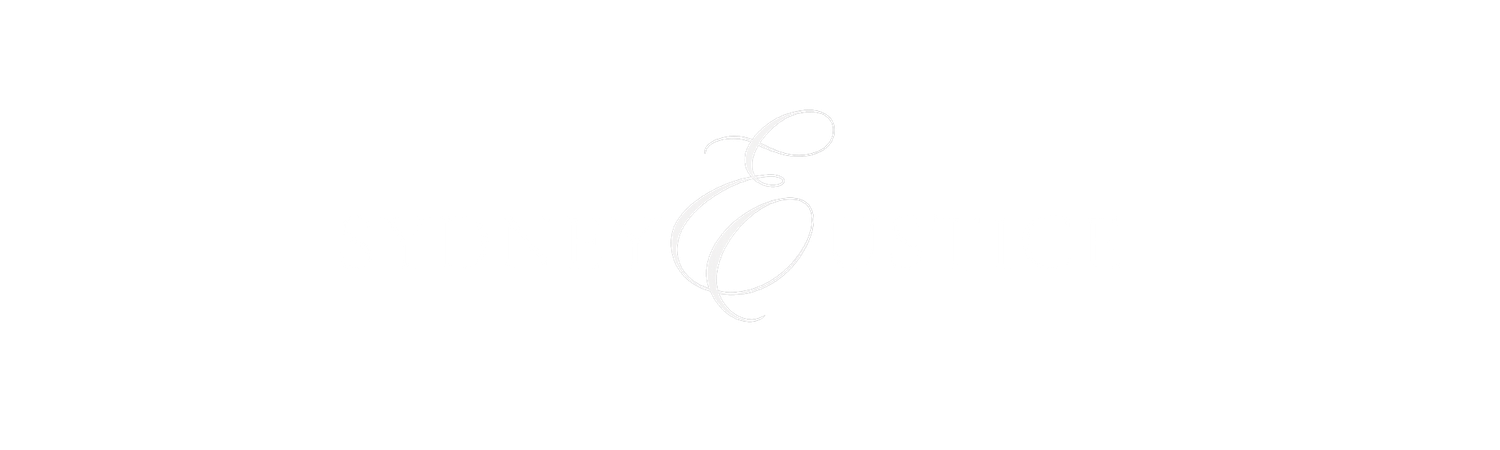 A minimalist sketch of a decorative letter E with elegant swirls on a white background.