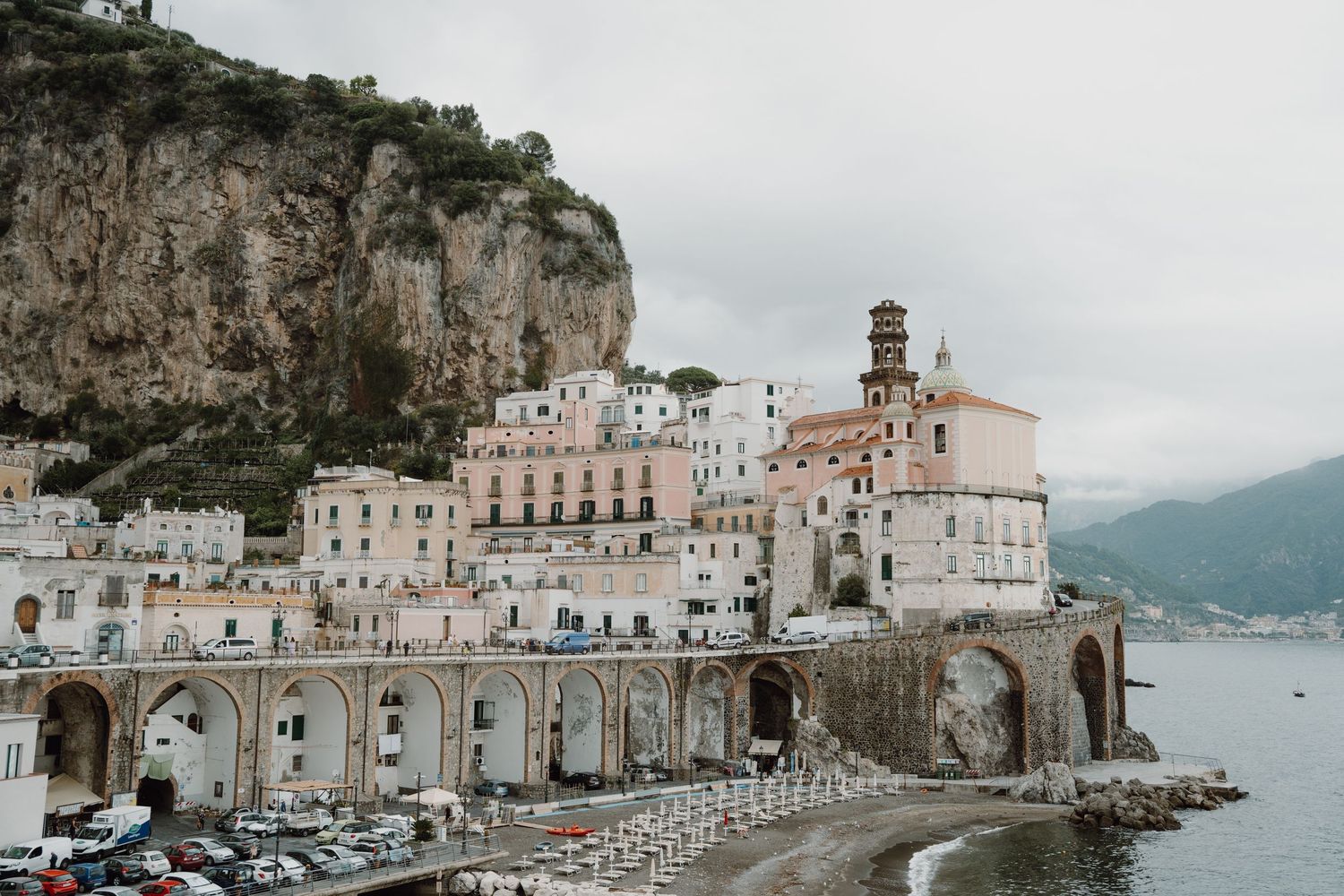 Scenic coastal Italian village with colorful buildings along Mediterranean waterfront.