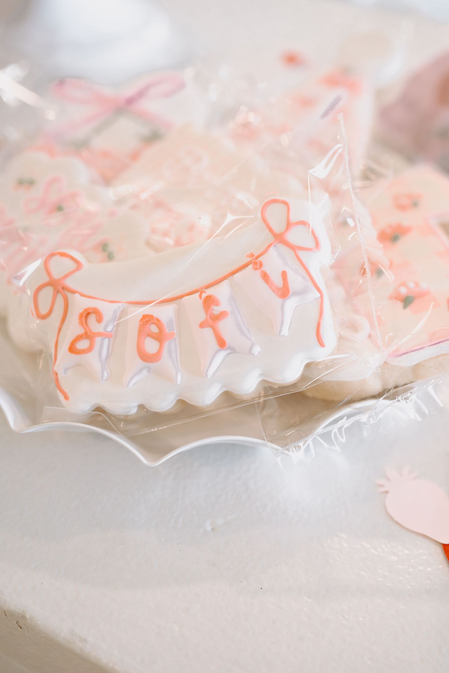 Close-up view of delicate pink and white decorative party streamers with scalloped edges.