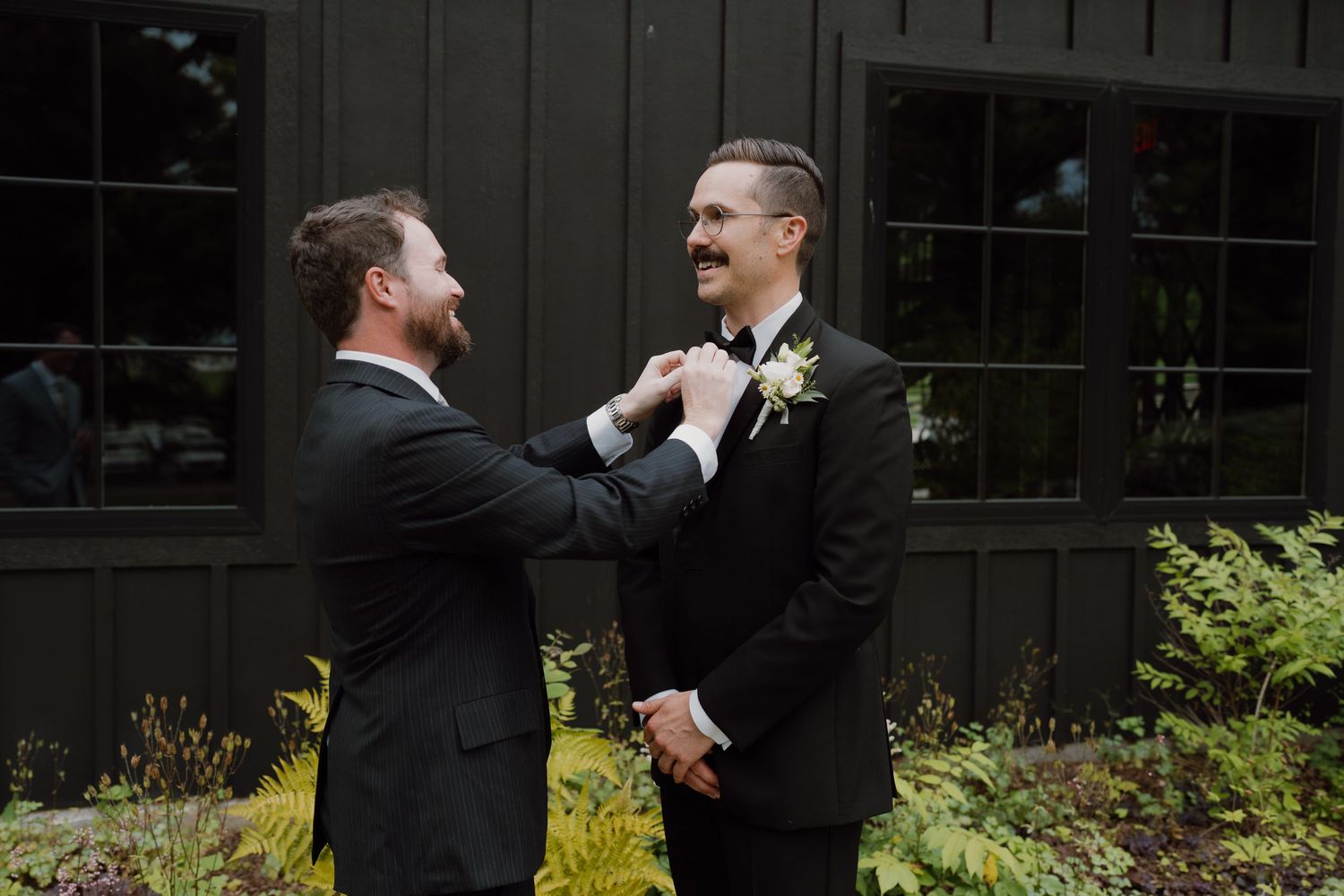 Joyful interactions between wedding party members during formal preparations.