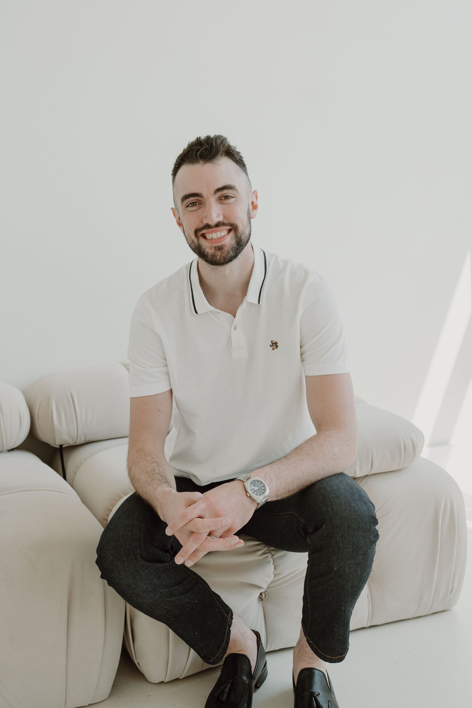 Casual portrait session in an all-white studio space with a comfortable sofa.