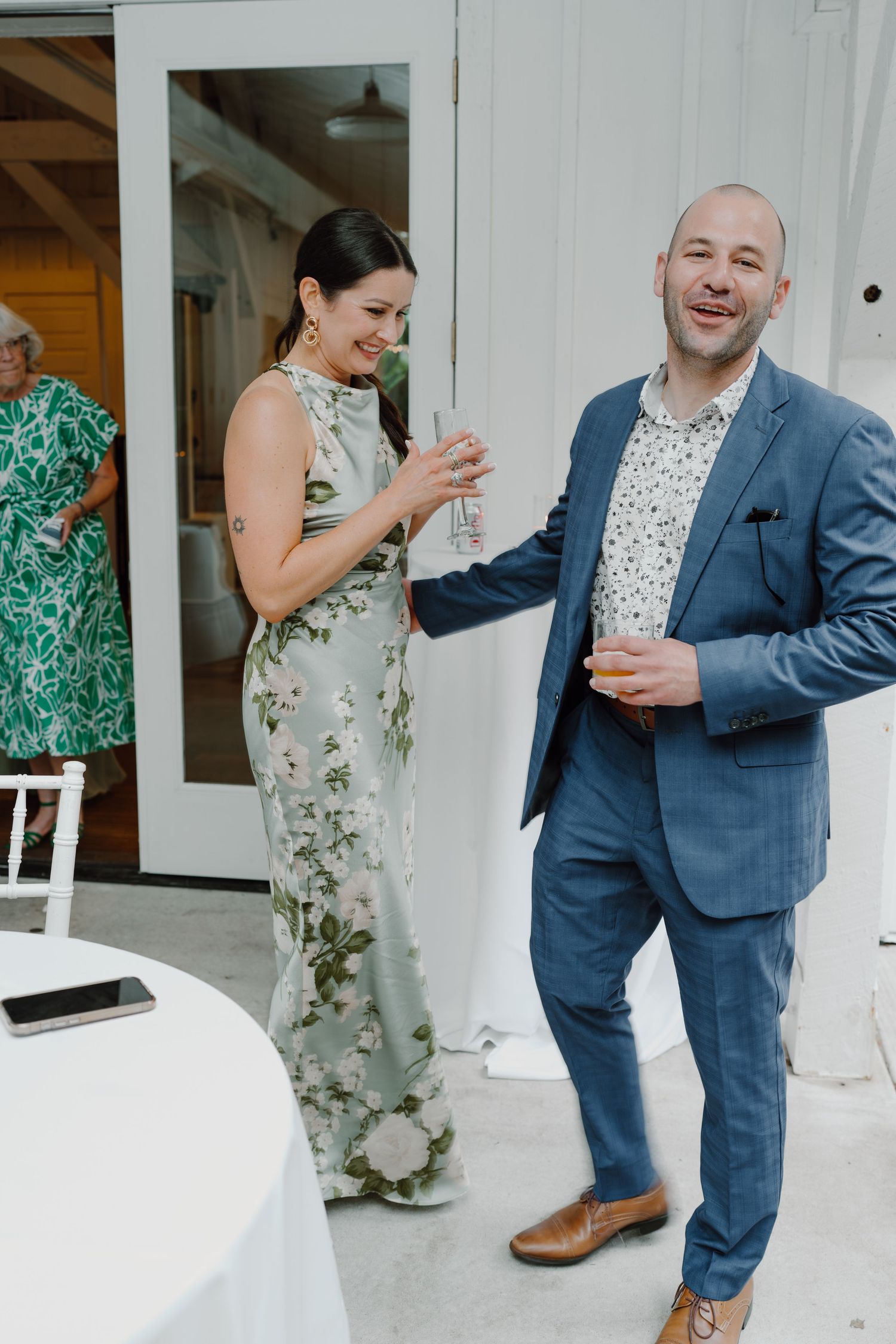 Candid moments of wedding guests laughing and dancing in formal attire.