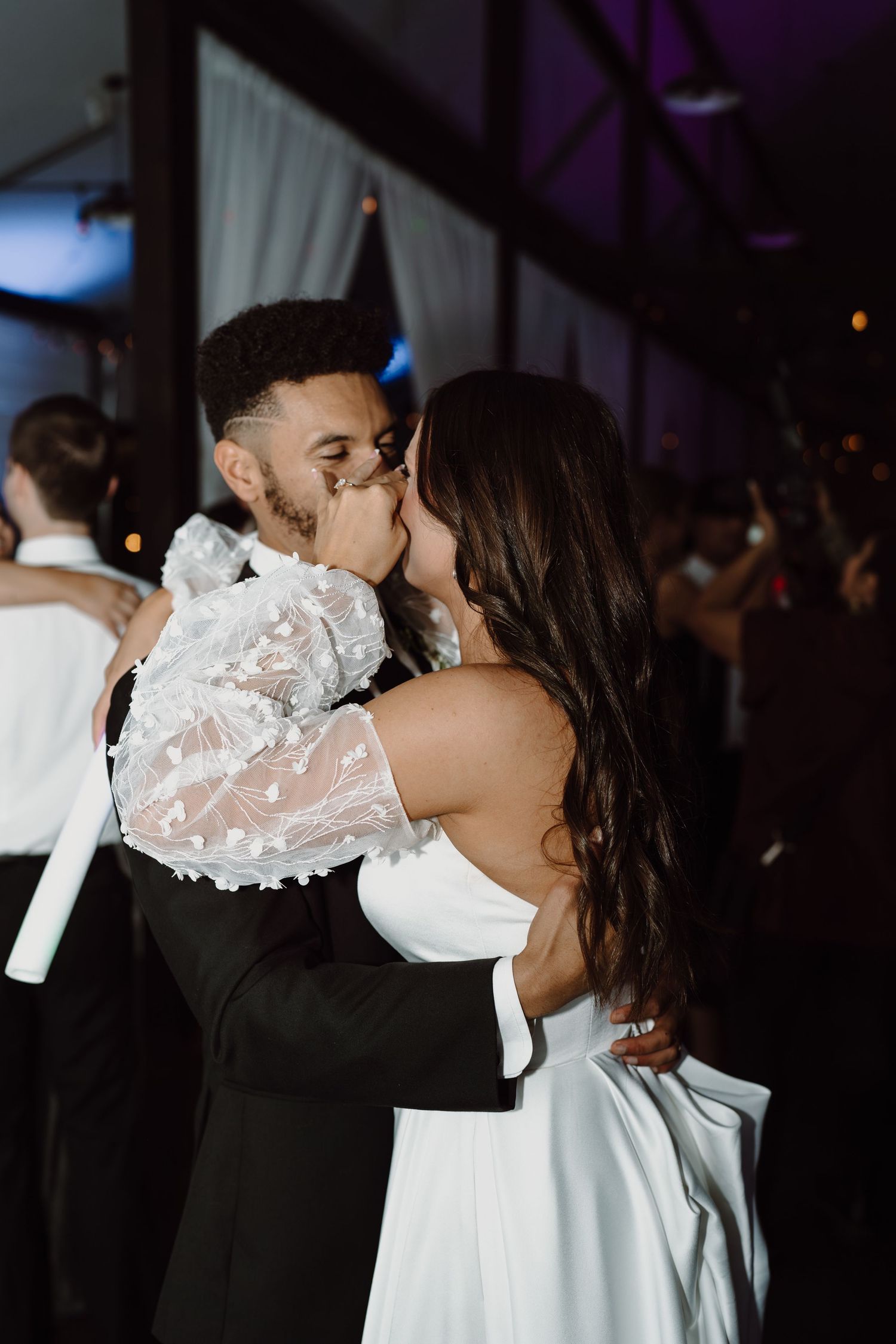 A romantic moment between newlyweds during their wedding reception dance.