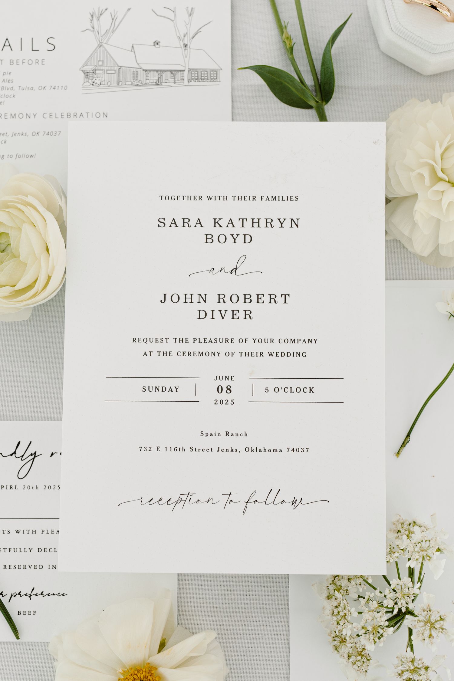 Elegant minimalist wedding invitation suite with white roses and delicate greenery.