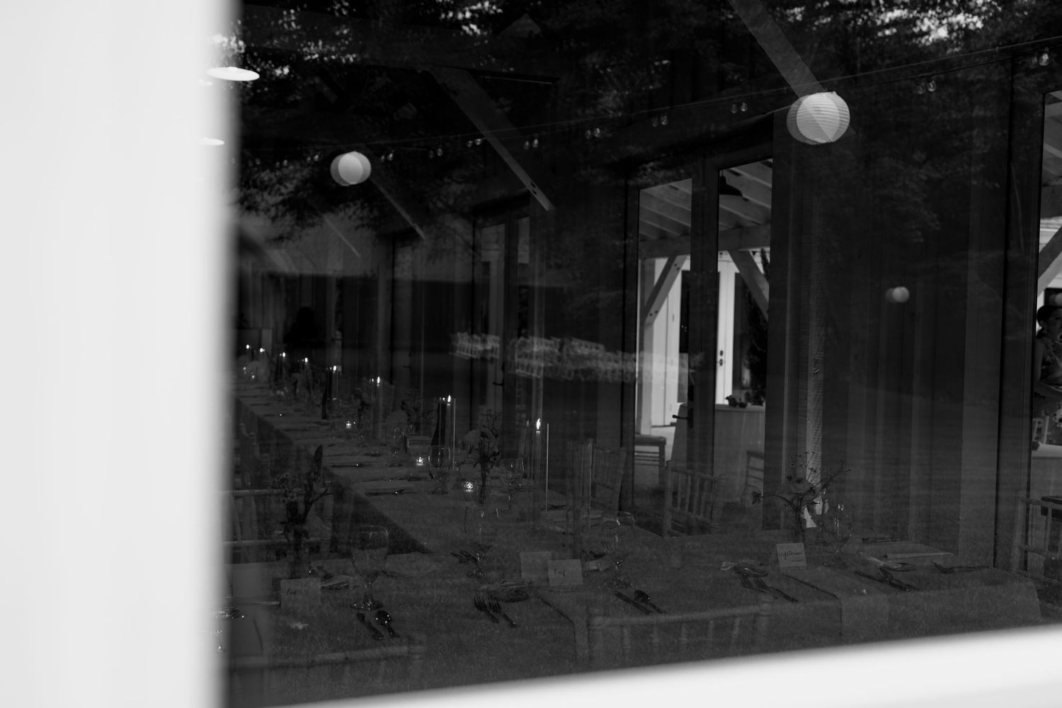 Black and white abstract architectural detail through window reflection.