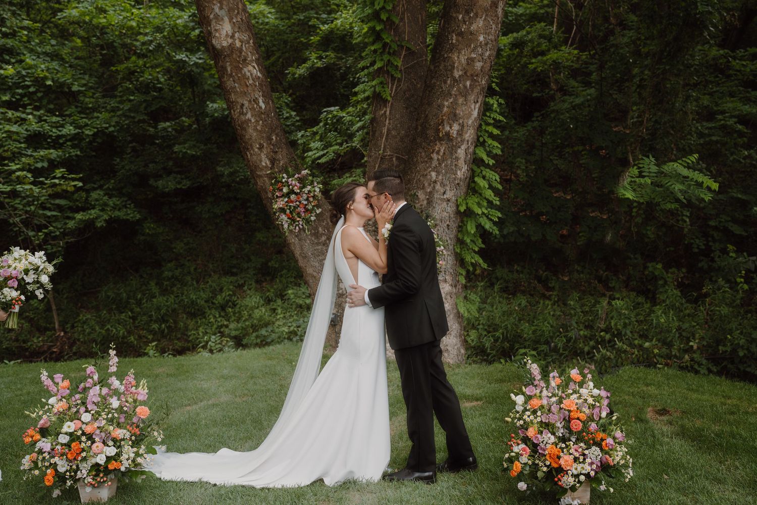 Forest wedding ceremony with elegant floral arrangements and natural woodland backdrop.