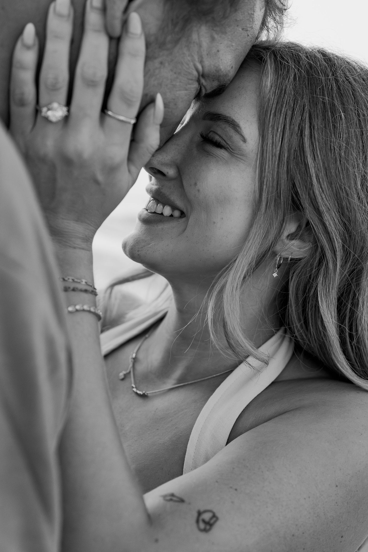 Close-up black and white shots of a romantic couple sharing intimate moments.