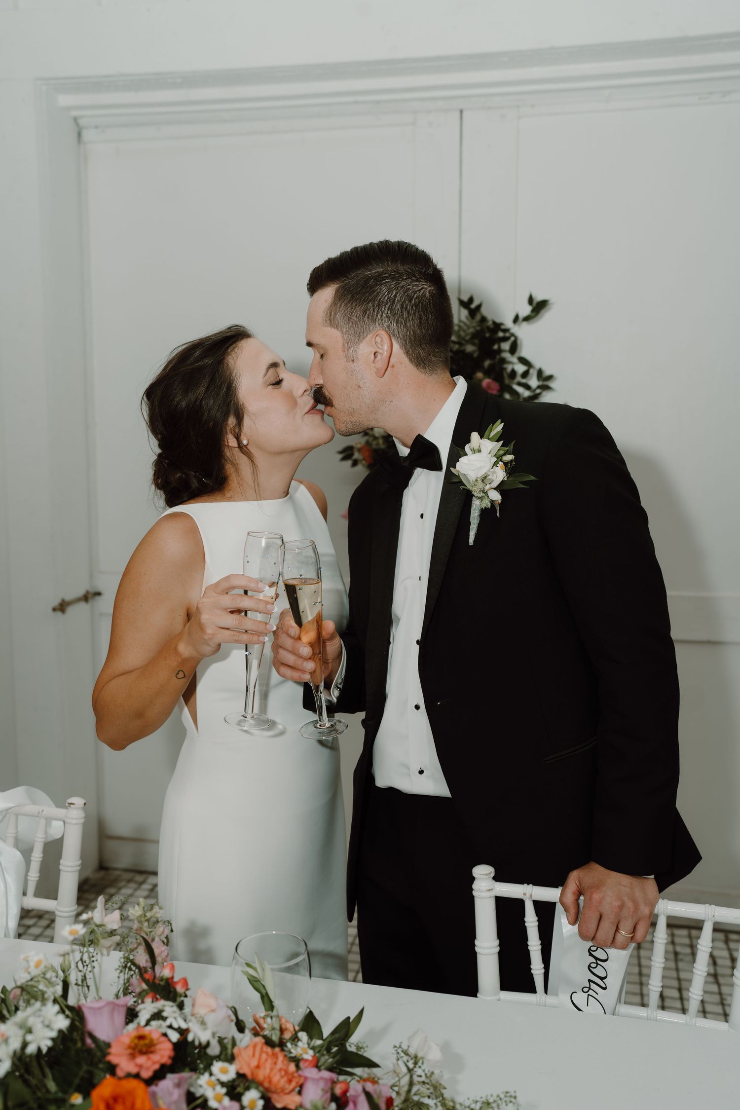 Romantic moment between newlyweds during their wedding reception toast.