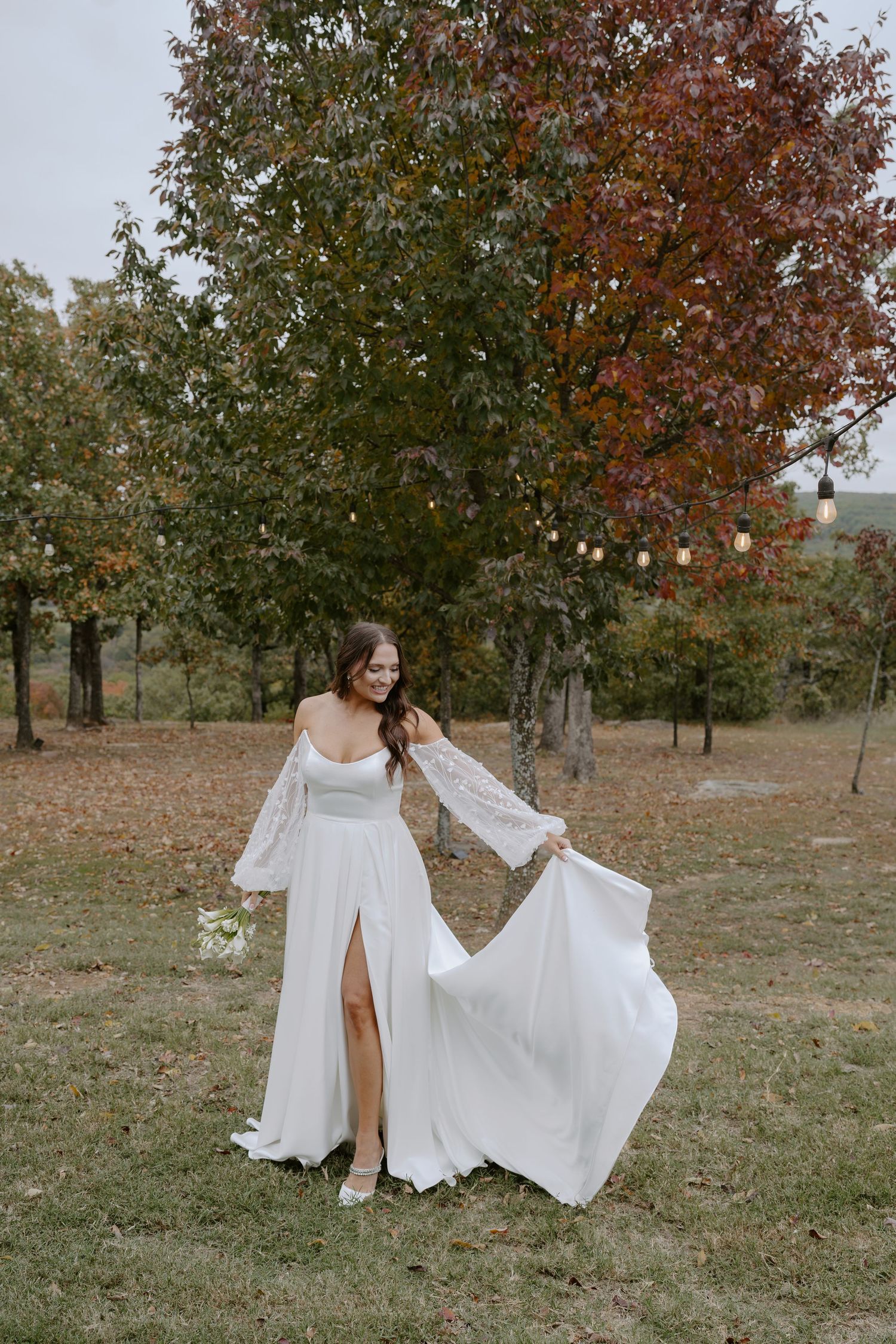 White wedding dresses captured in artistic motion during fall outdoor photoshoot.