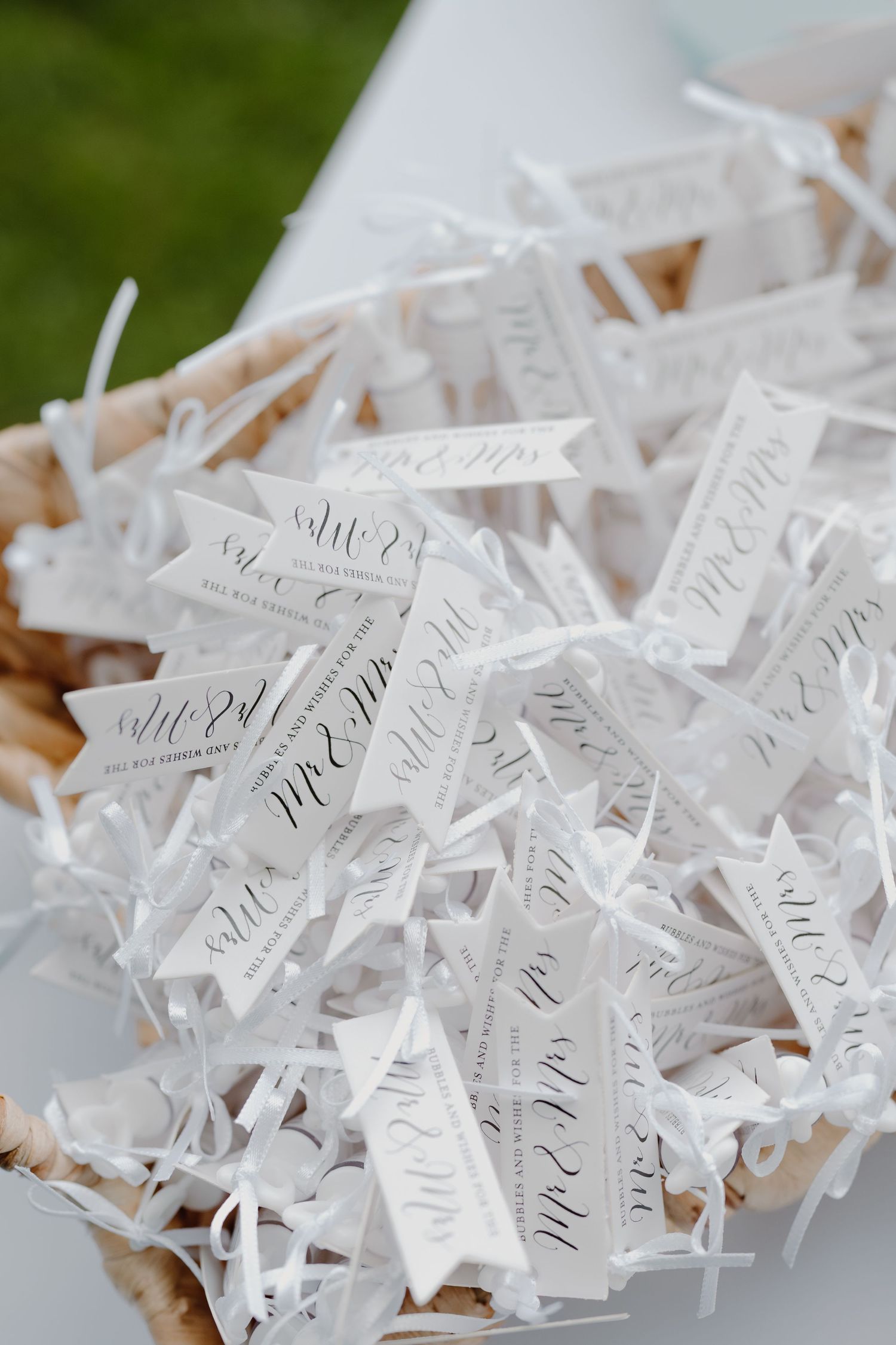 Wedding favor tags with elegant calligraphy displayed in rows.
